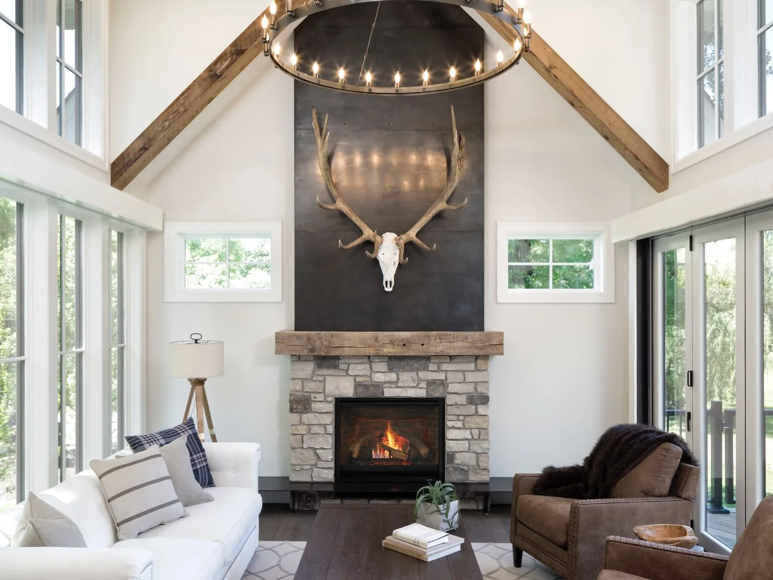 Stone fireplace in a tall white great room