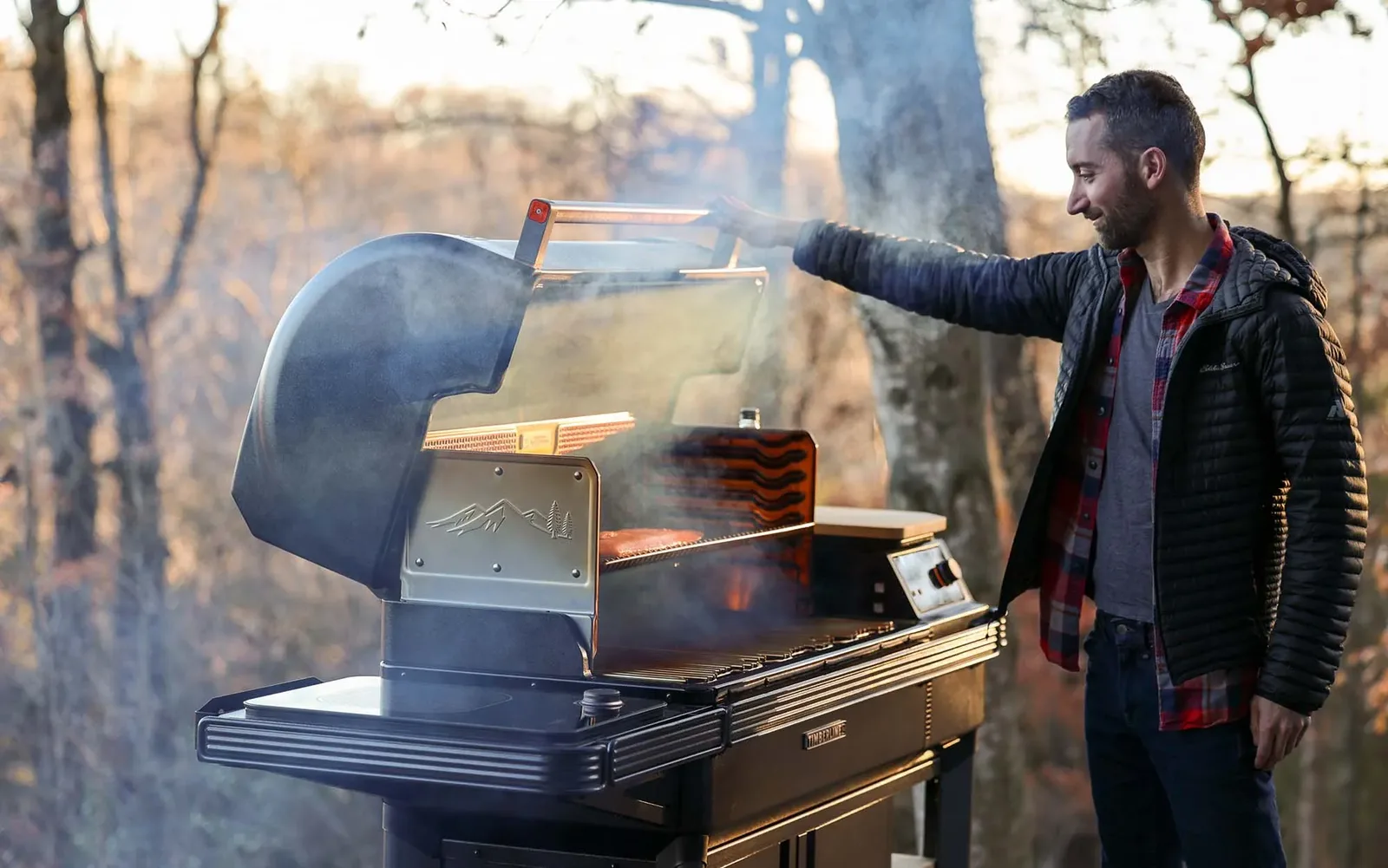 Smoke rolling out of a Traeger pellet grill