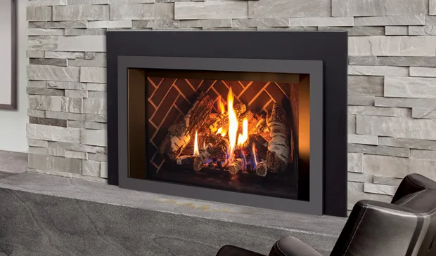 Gas insert burning in a stacked stone fireplace