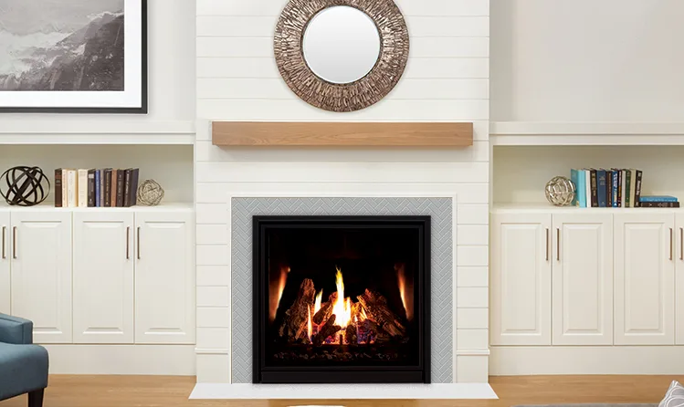 Gas fireplace with a wood mantel in a white shiplap living room