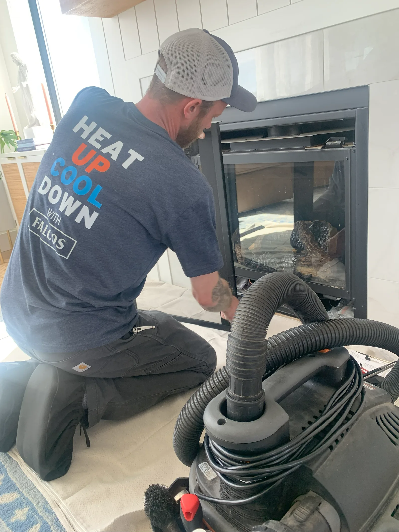 A Falco's technician servicing a gas fireplace