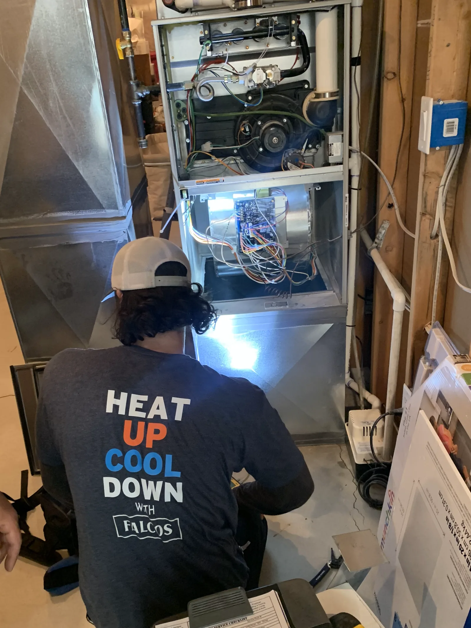 Falco's service technician working inside a furnace cabinet