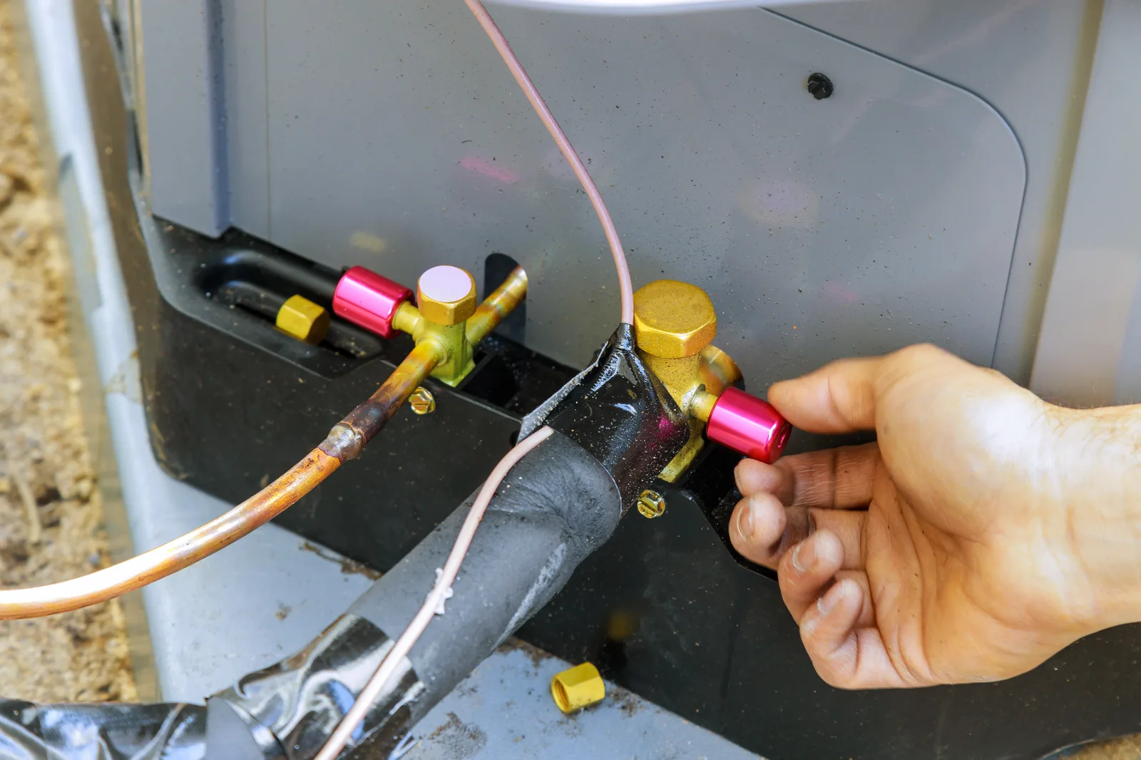 Refrigerant gauges connected during an air conditioner service call