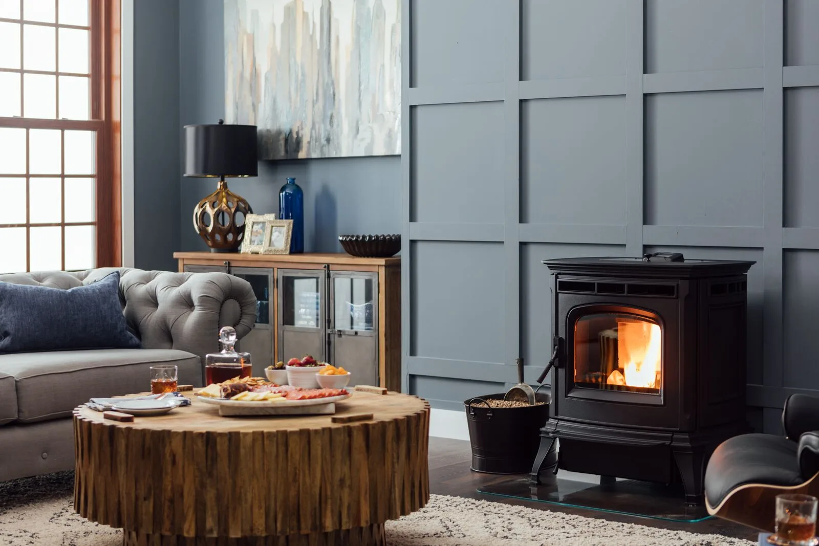 Pellet stove burning in a blue-paneled living room